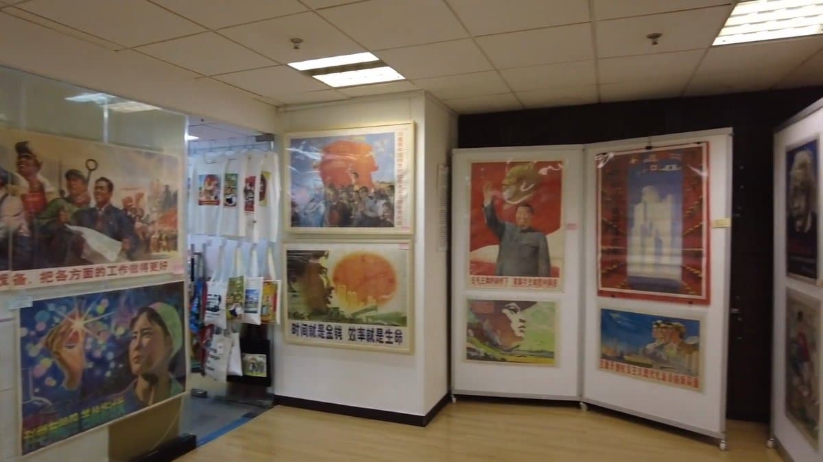 Gallery corridor lined with framed posters