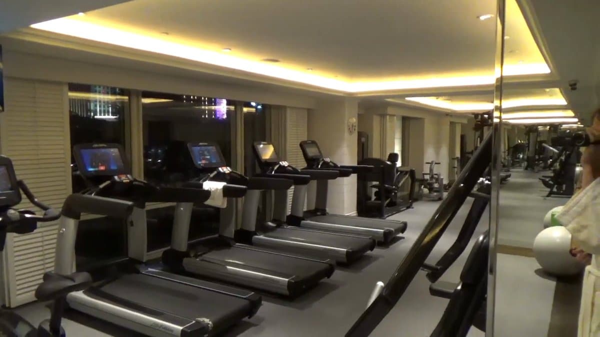 Gym treadmills facing mirrored wall