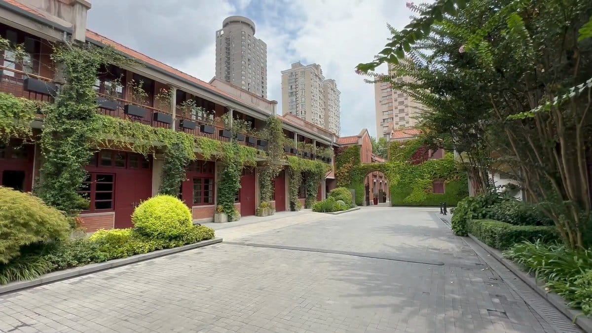 Lane houses against city towers