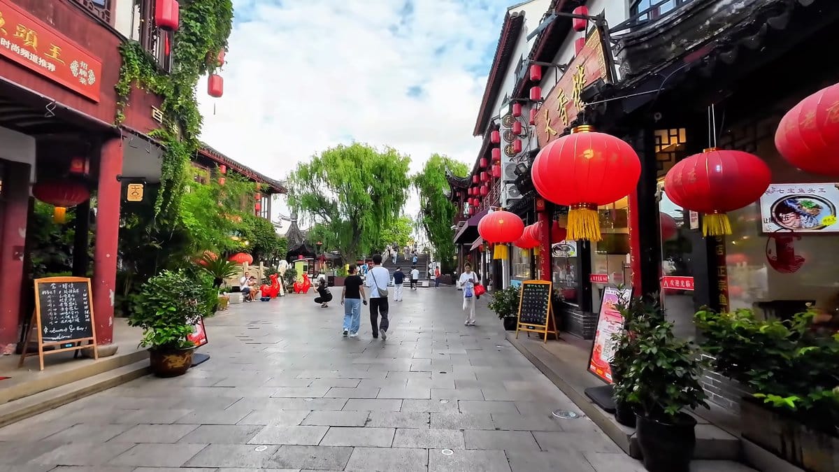 Lantern-hung street beside willow trees