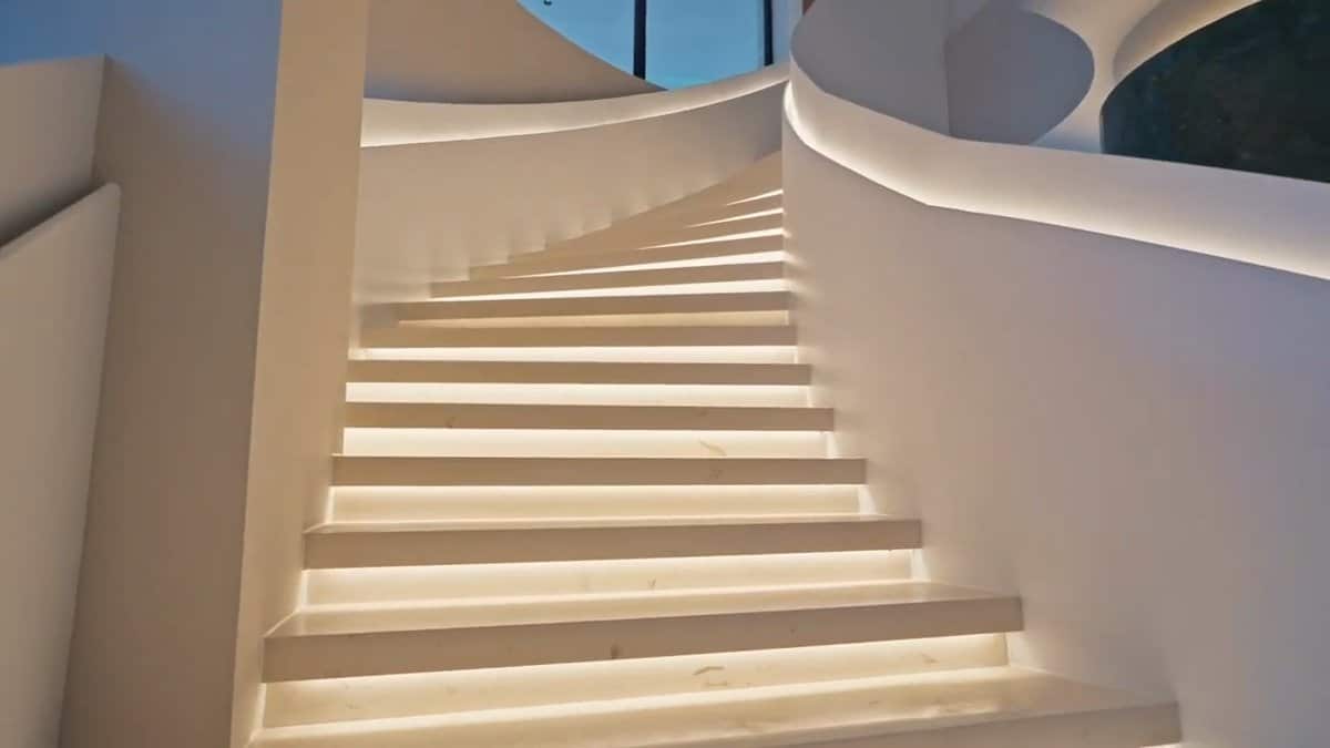 Lit curving white staircase