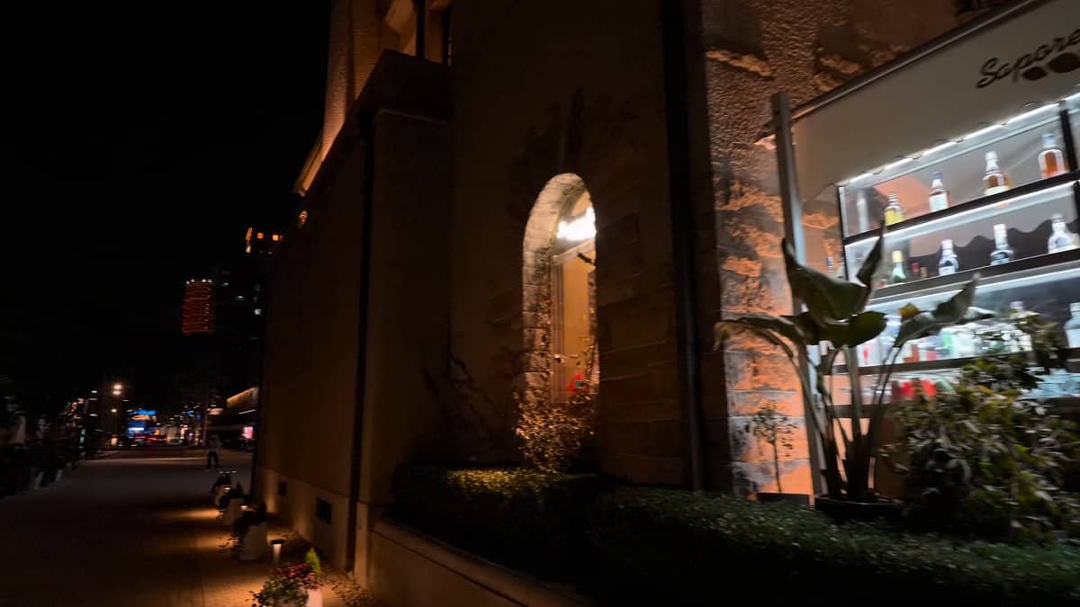 Lit shop in a brick archway