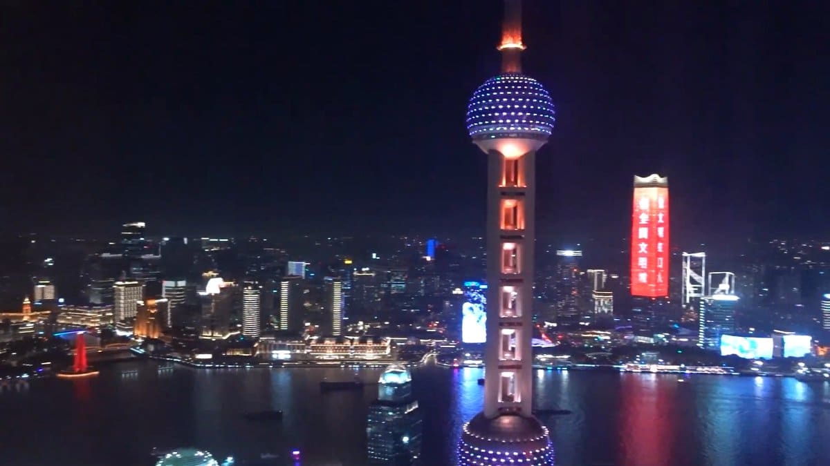 Oriental Pearl glowing blue at night