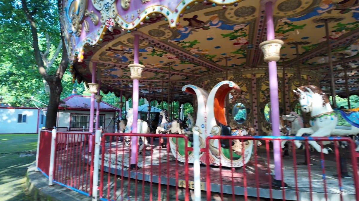 Painted carousel horses on their poles