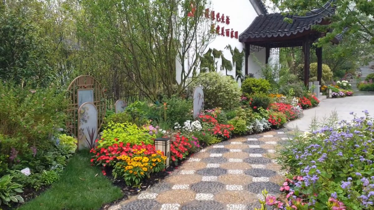 Patterned stone path through flower beds