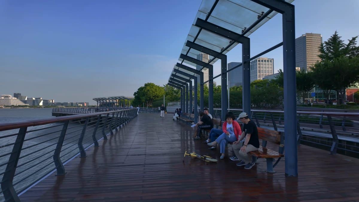 People resting under a glass shelter