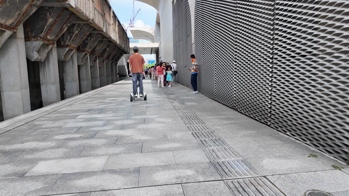 Plaza along faceted metal wall