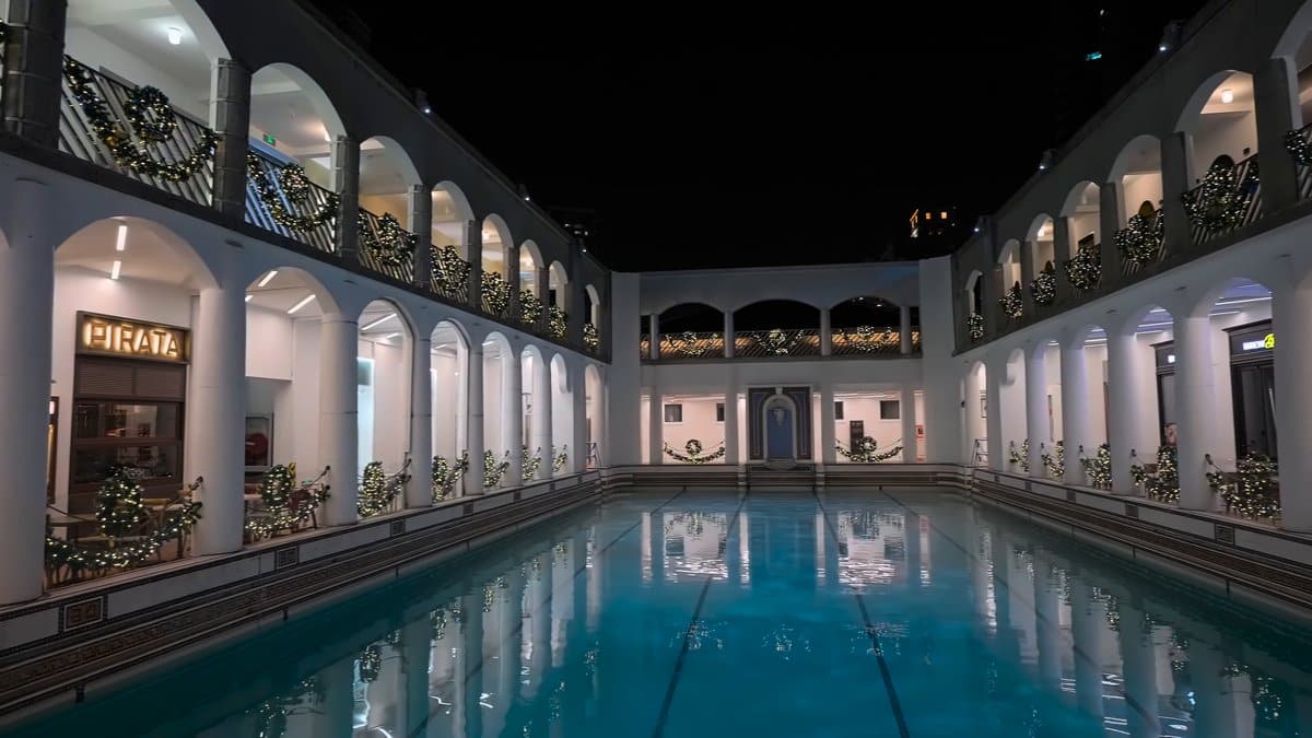 Pool mirrored between night arcades
