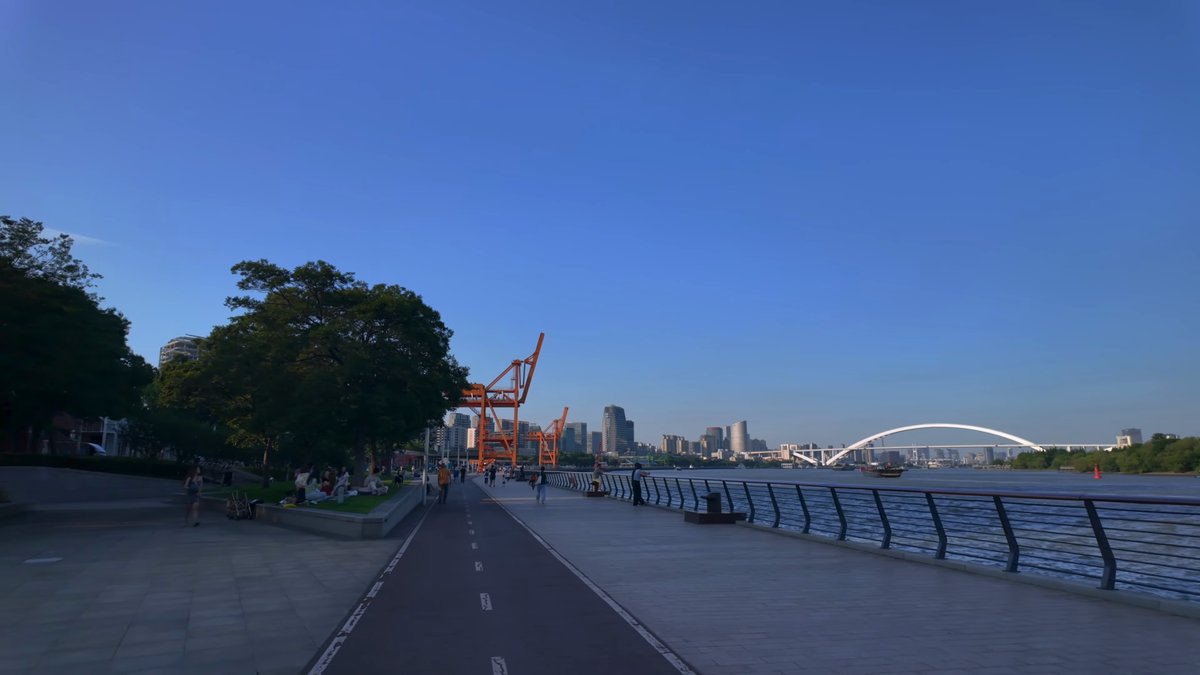 Promenade with crane and arched bridge