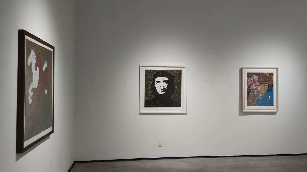 Quiet gallery with three framed works