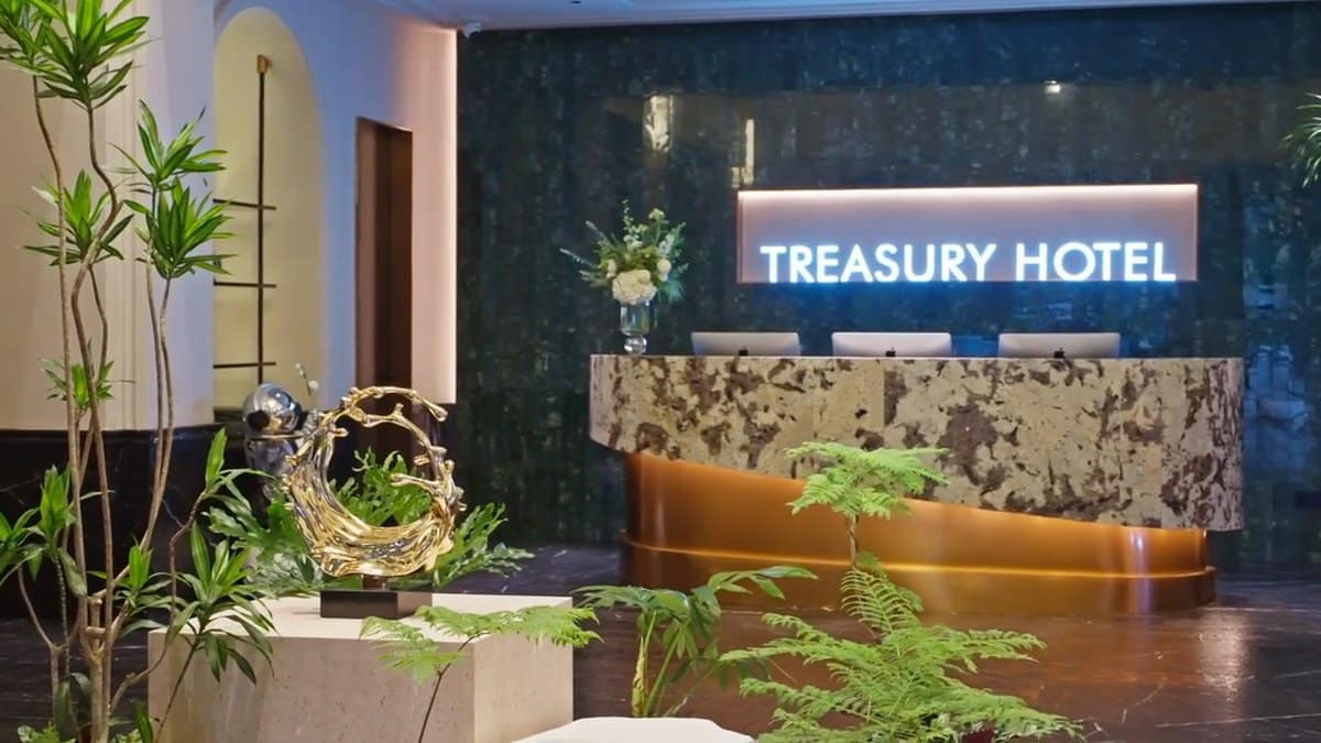 Reception neon Treasury Hotel sign