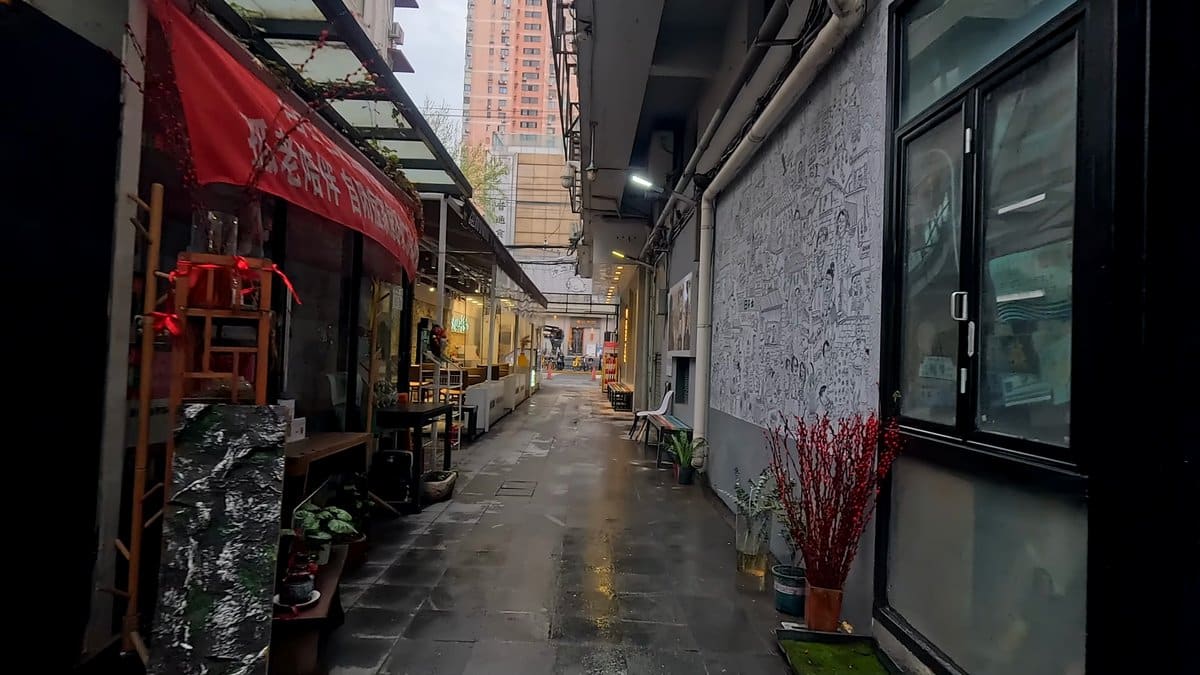 Red awning beneath modern towers
