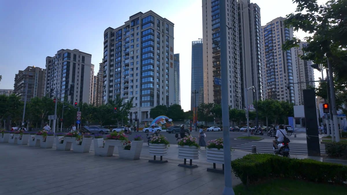 Residential towers seen across a paved plaza with