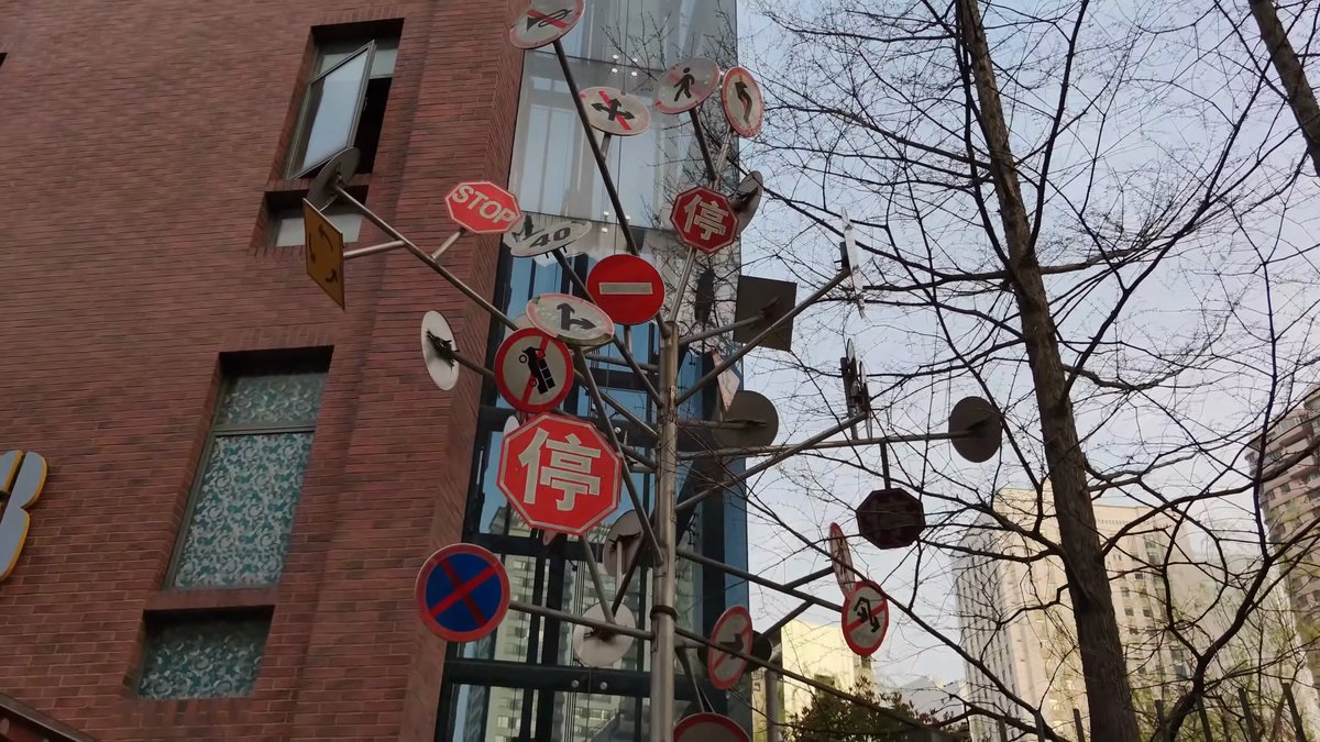 Round enamel signs and discs hung along a