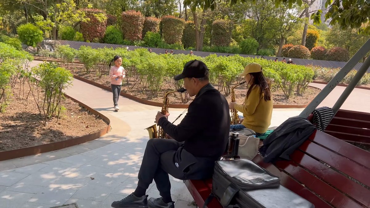 Saxophonist playing beside the path