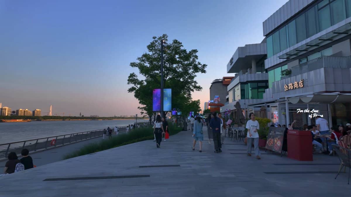 Shops and river promenade at dusk