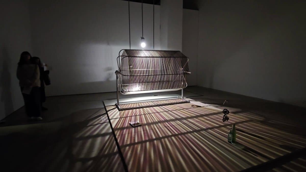 Slatted metal frame in dark gallery