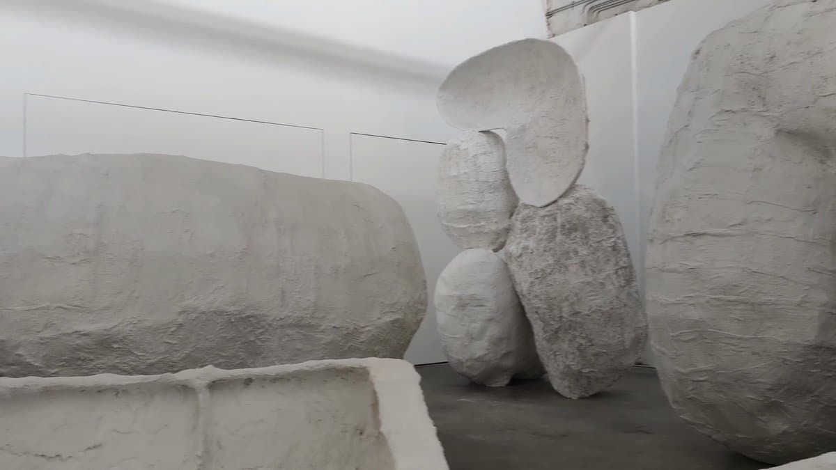 Smooth boulder sculptures across the floor