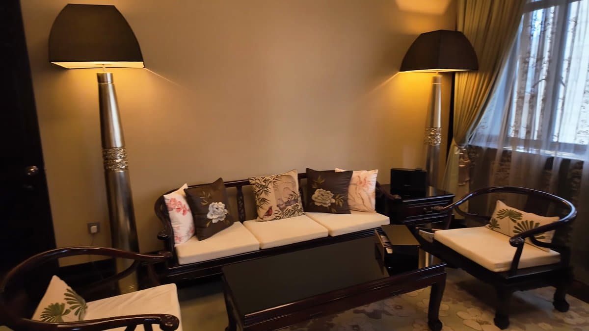 Sofa between twin floor lamps