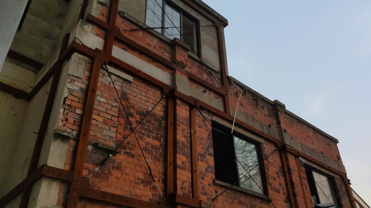 Steel-braced derelict mill facade