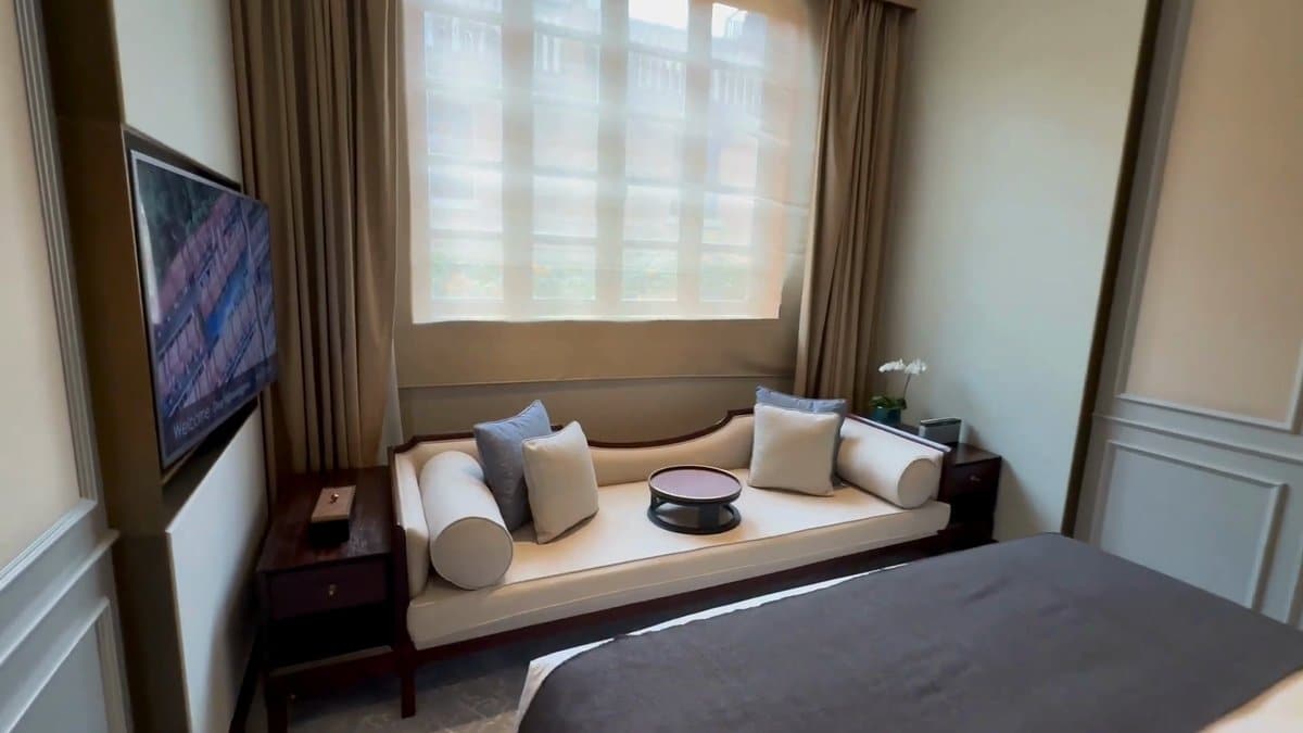 The bedroom from the corner, the television on