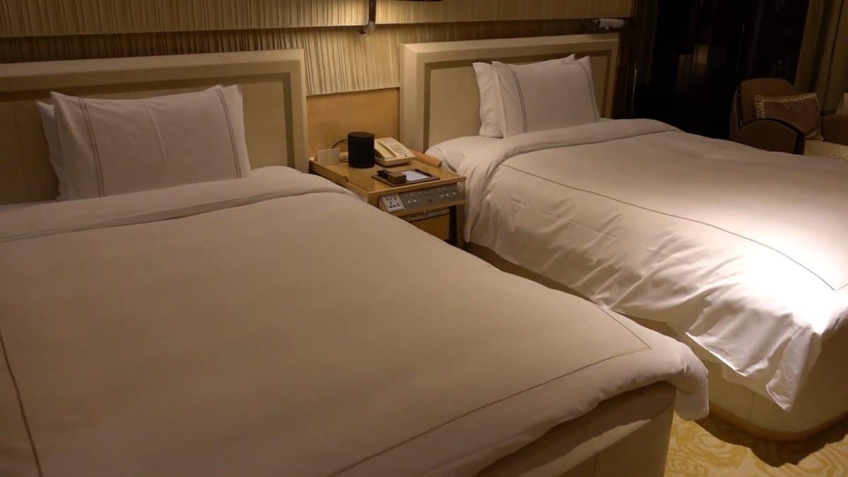 The beds from the foot, the nightstand and