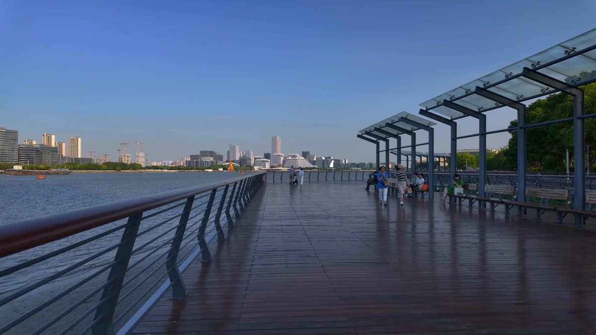The boardwalk under its steel canopy with walkers