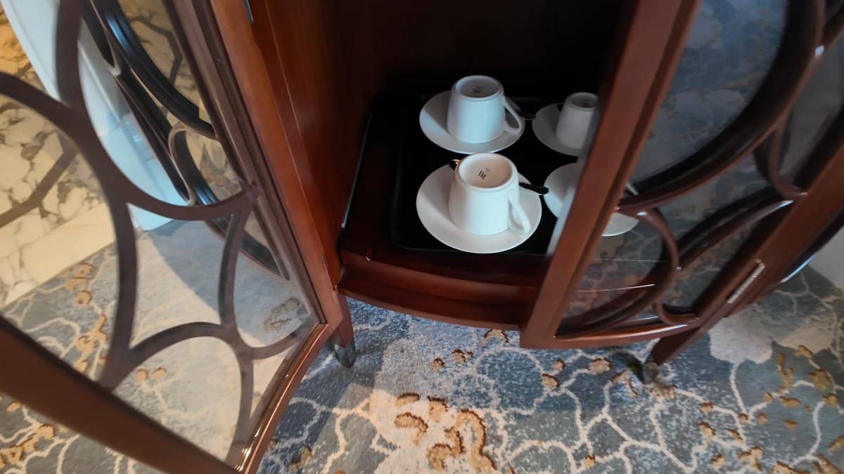 The cabinet below opened to show white cups