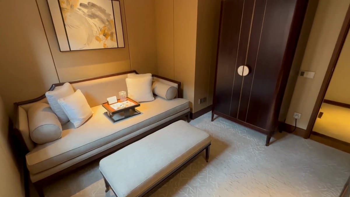 The daybed beside a tall panelled wardrobe, the