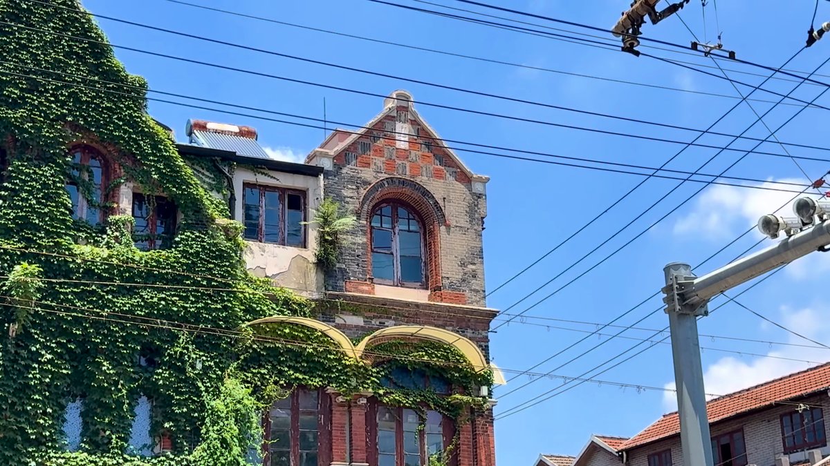 The ivy-covered brick mansion with its arched windows