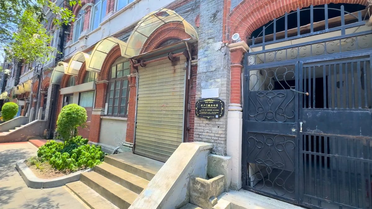 The lane with arched openings, a shuttered bay,