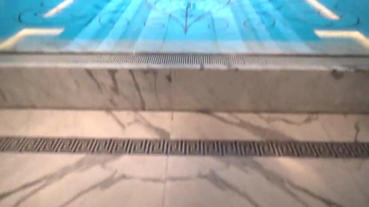 The marble lip of the pool close up,