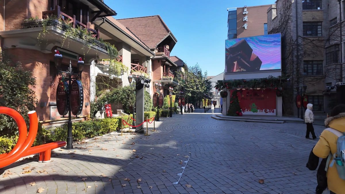 The plaza with the screen lit above, a