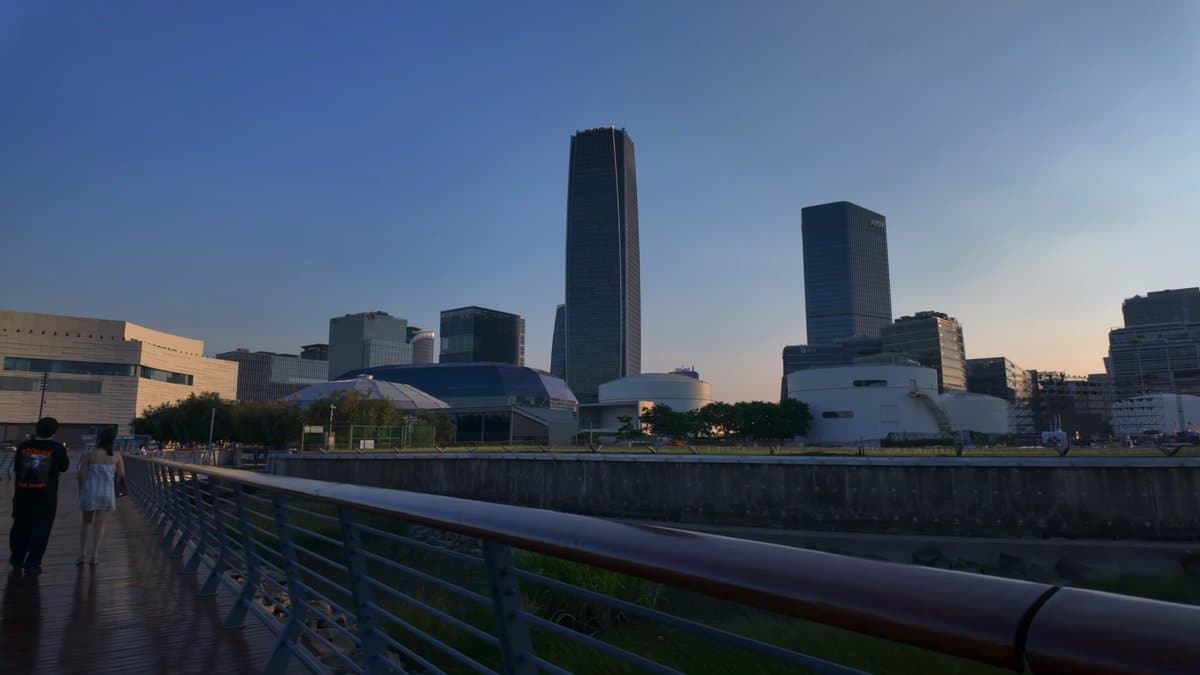 The promenade at dusk, a tall tower standing