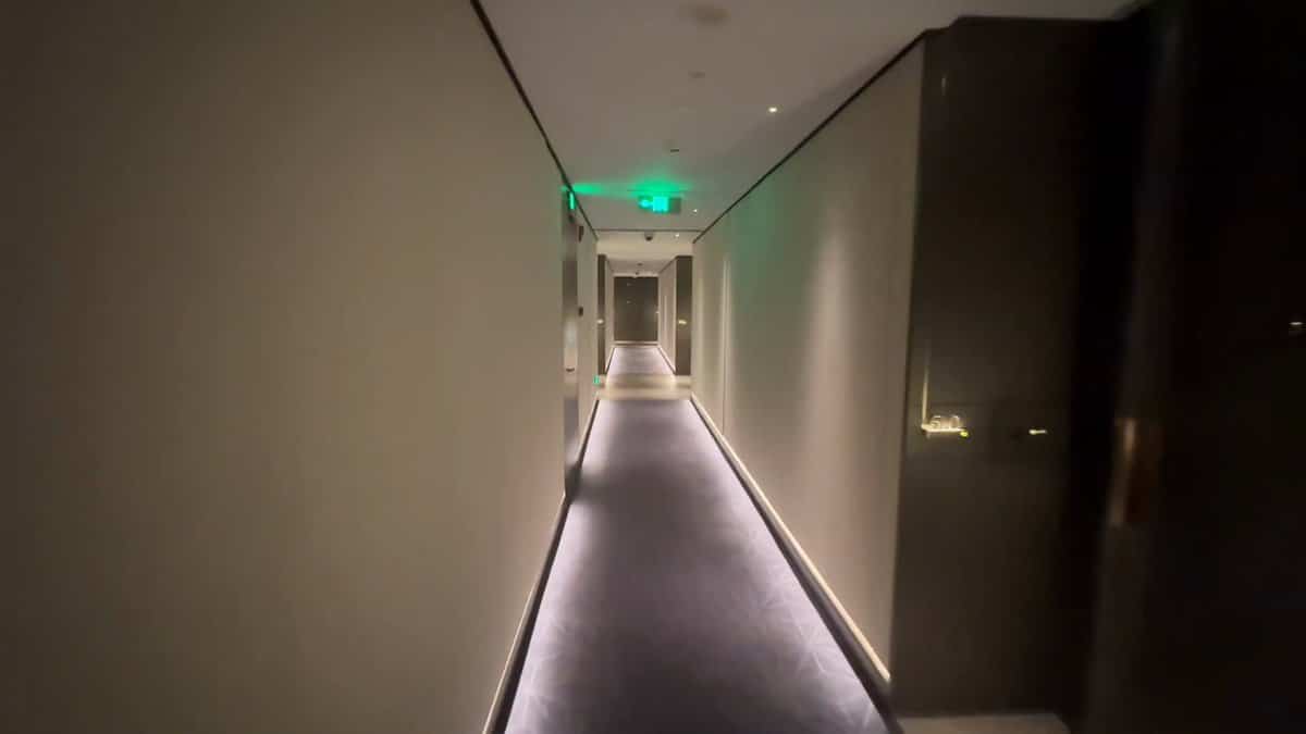 The same corridor further along, the carpet running