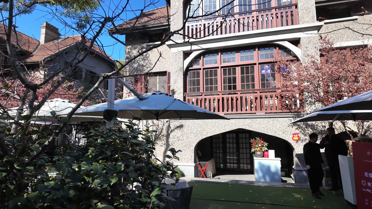 The same frontage with people standing under the