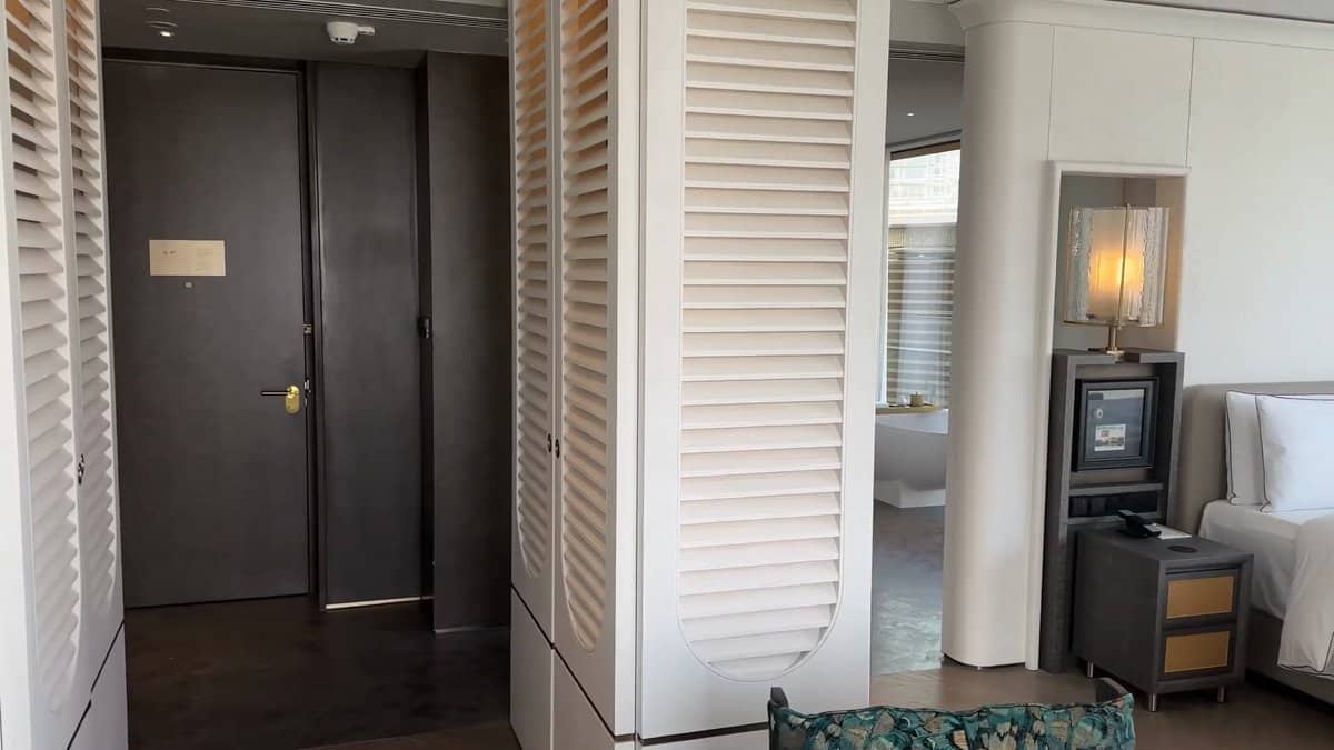 The suite doorway framed by louvred shutters, the