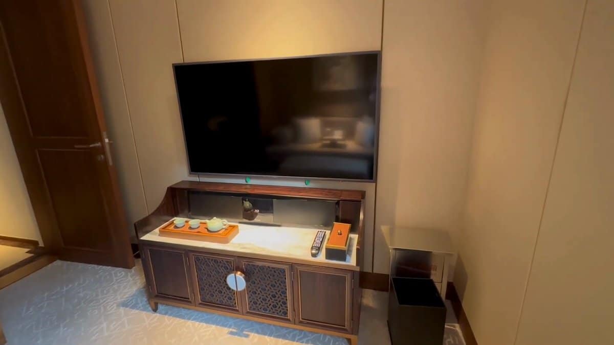 The television on a carved console with a