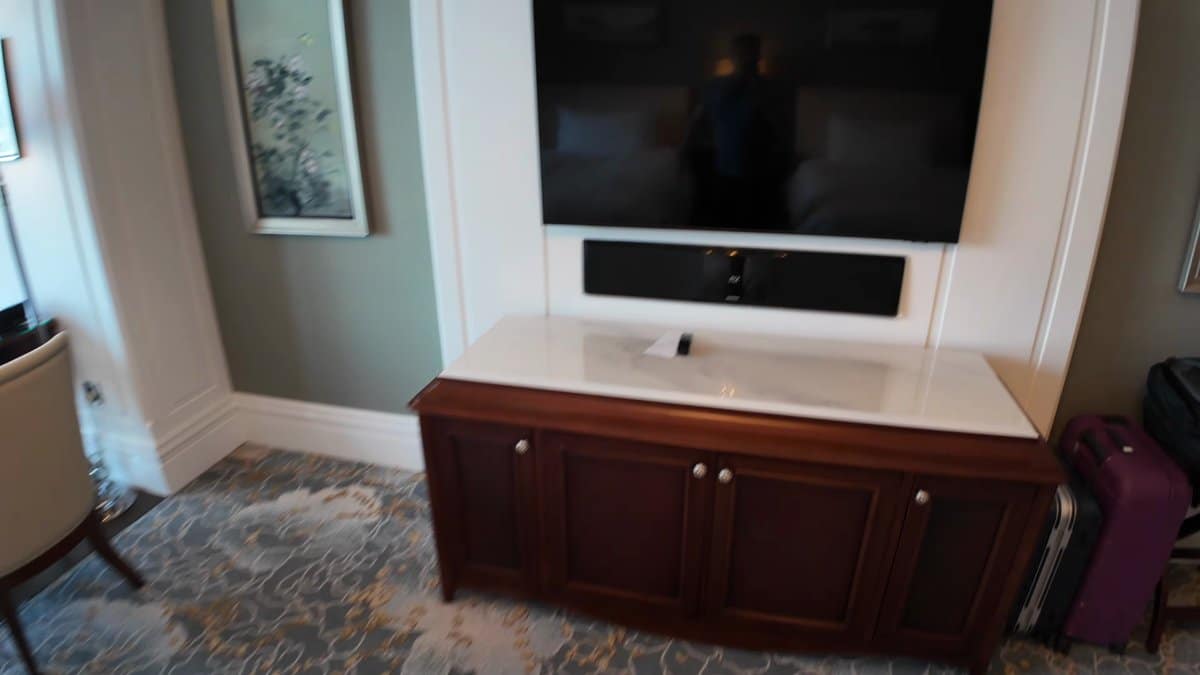 The television on the mahogany cabinet facing the