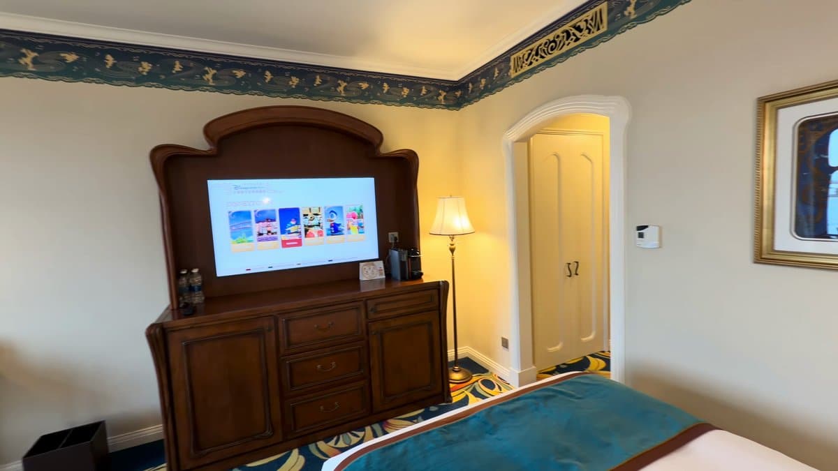 The television switched on above the cabinet, the