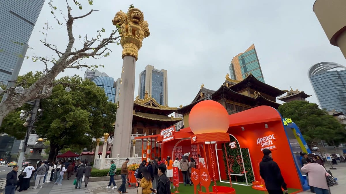 The temple beside an orange Aperol Spritz pop-up