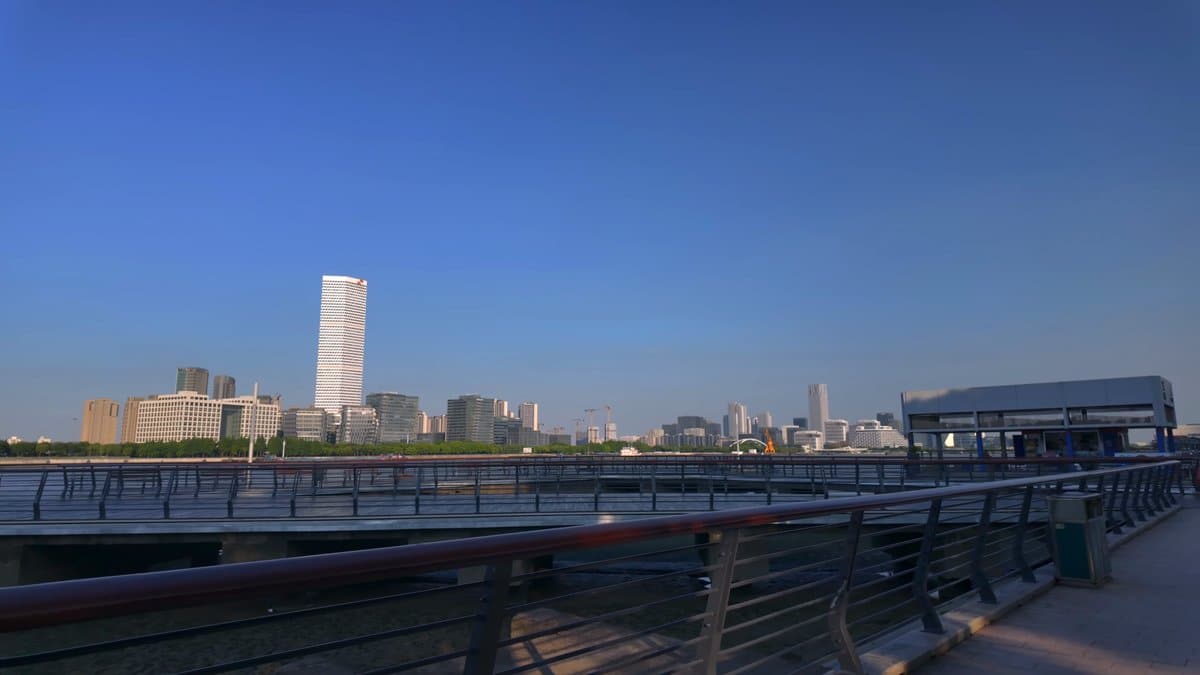 The waterfront at dusk, a pale tower standing