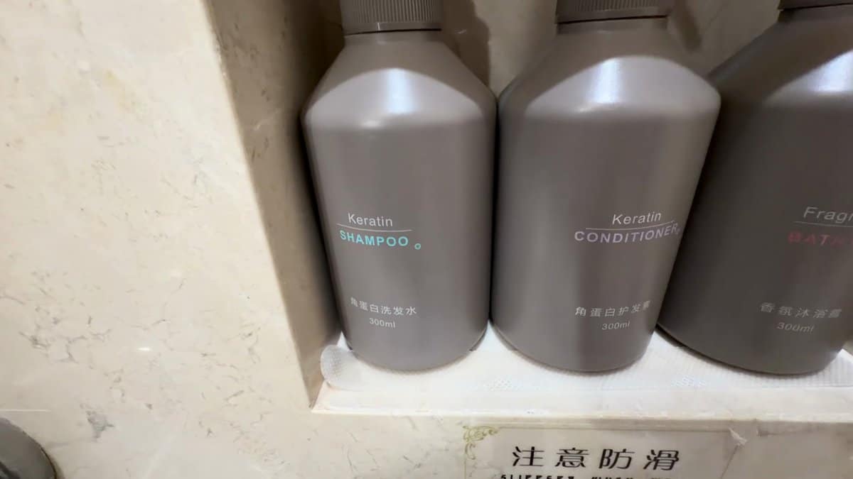 Three grey 300ml pump bottles in a marble