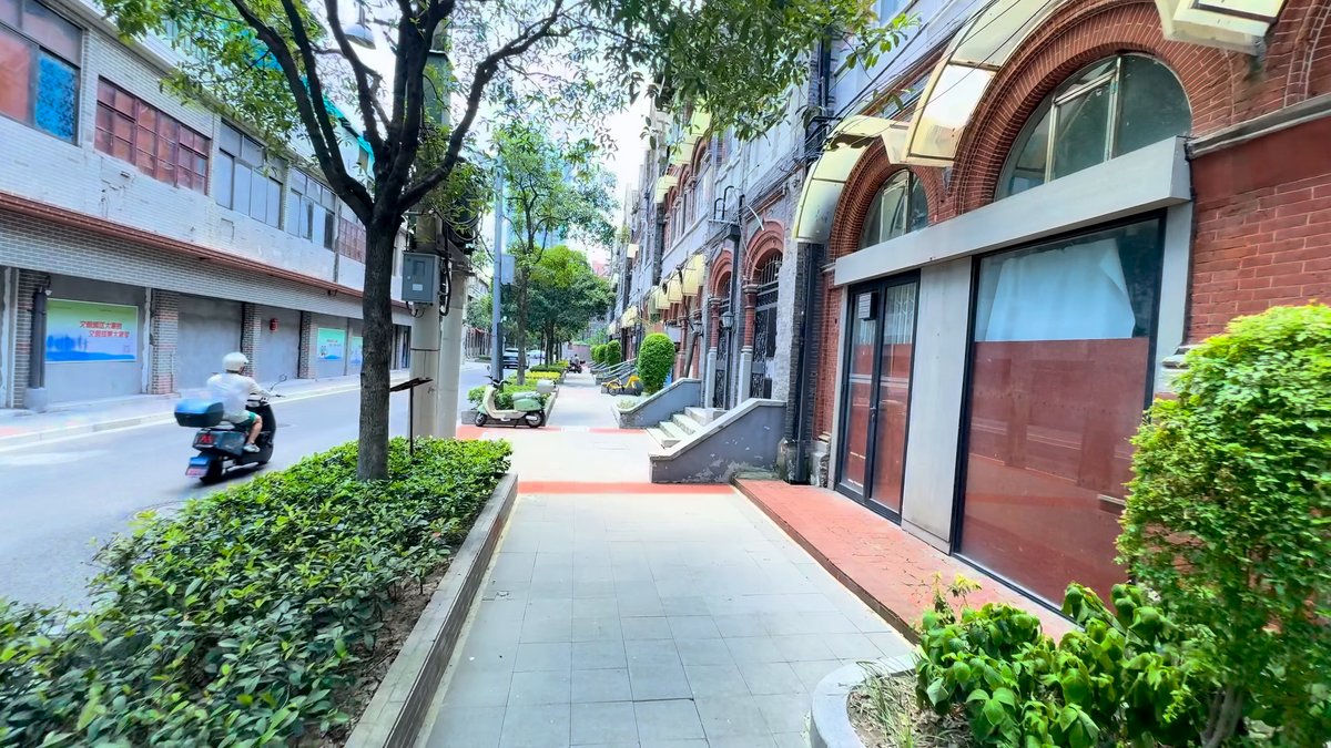 Tree-lined street of brick arcades