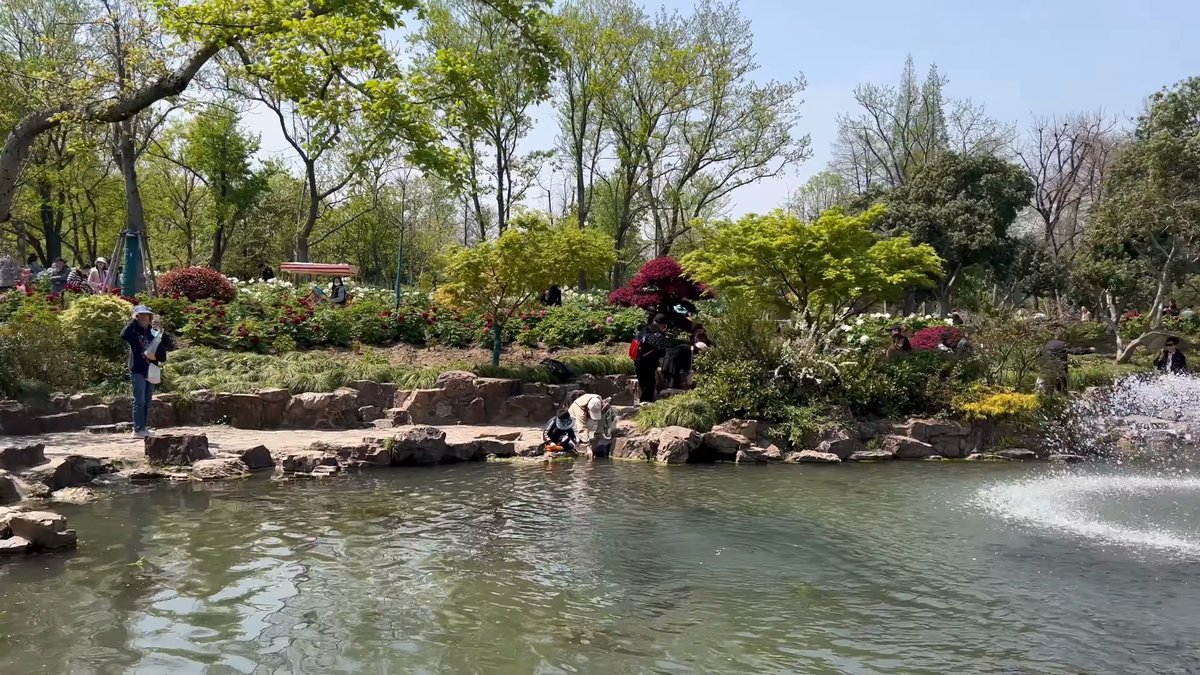 Twin fountains along planted pond