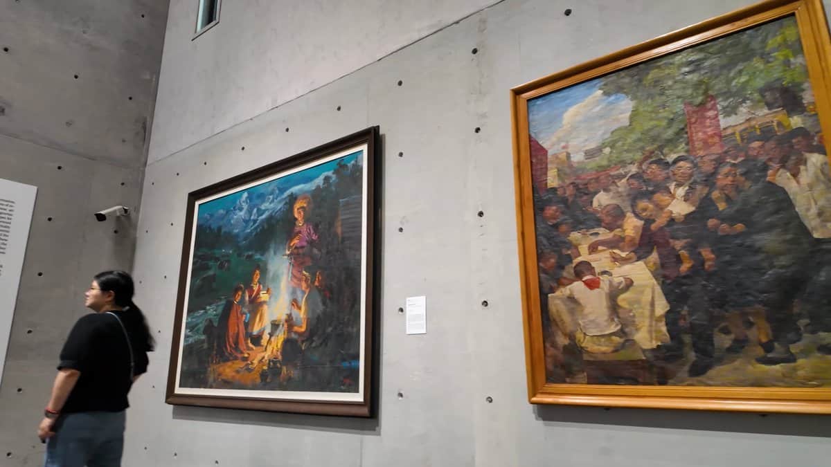 Visitor studying two large canvases