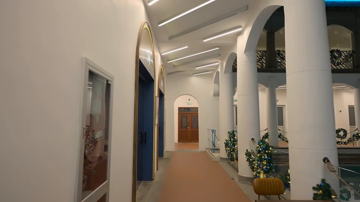 White arcade with trained greenery