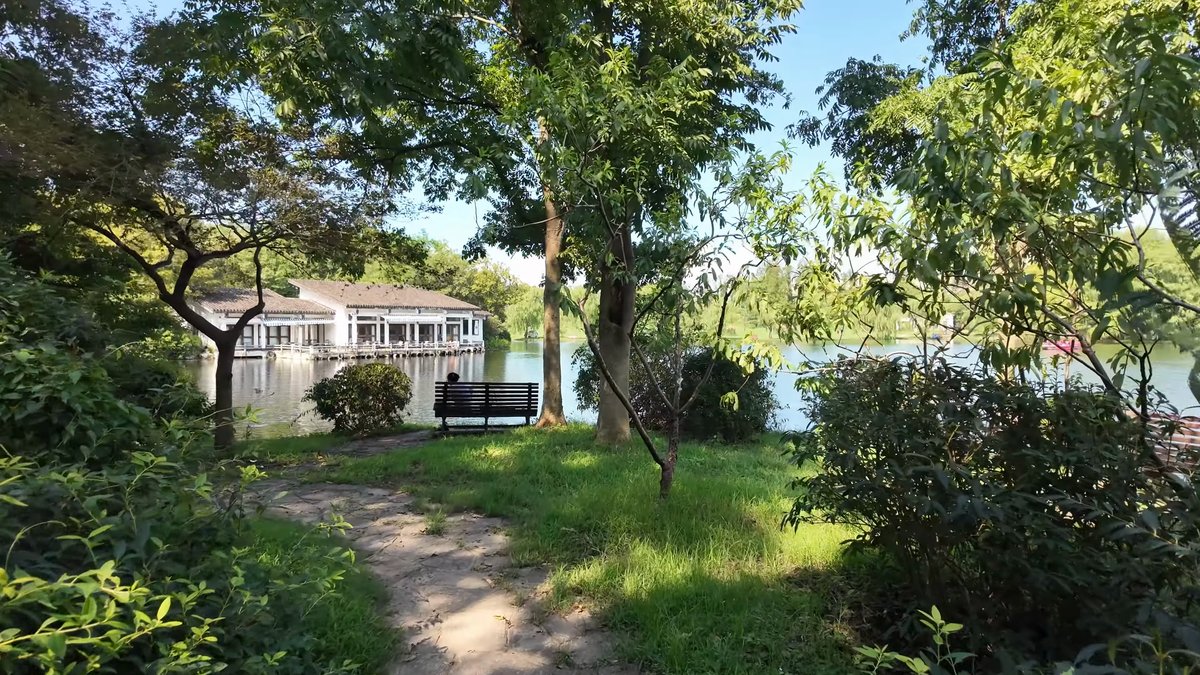 White boathouse among lakeside trees