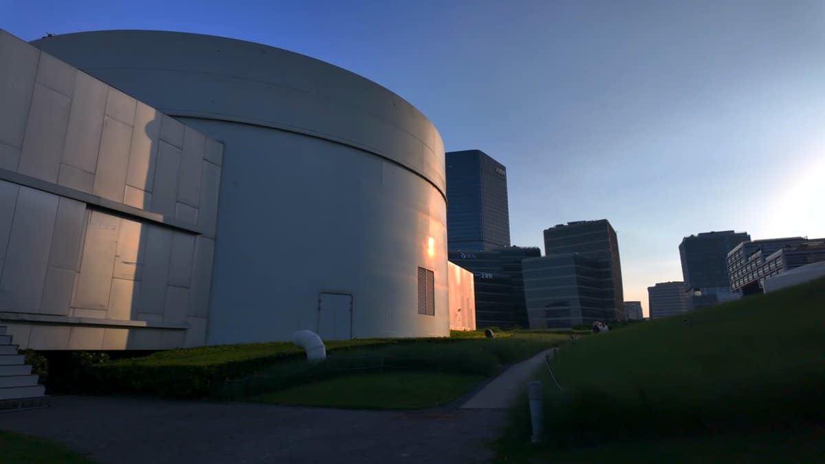 White drum-shaped museum against the city