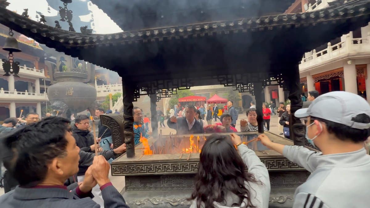 Worshippers lighting incense sticks